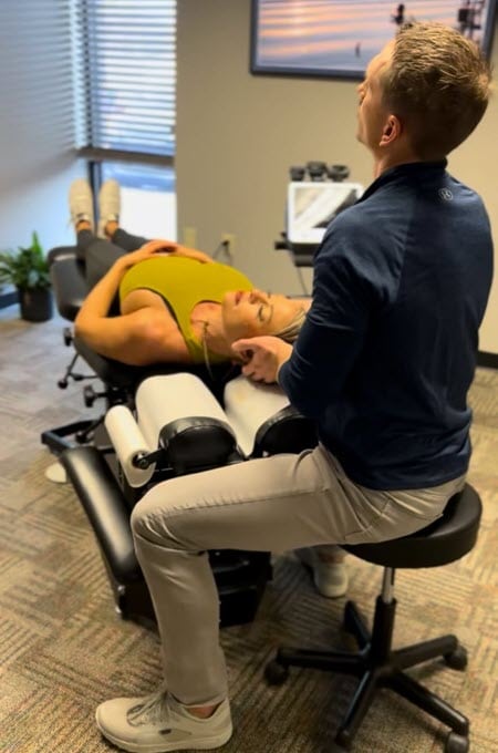 Chiropractor providing neck pain relief through spinal adjustments.